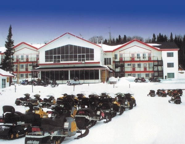 Lodge and snowmobiles parked for winter