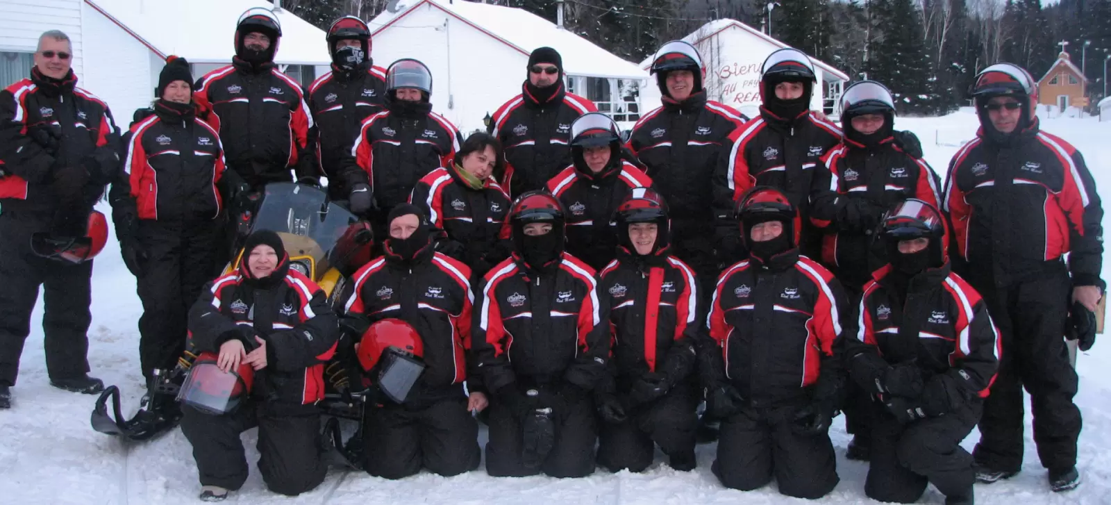 Group of snowmobilers in front of the outfitter
